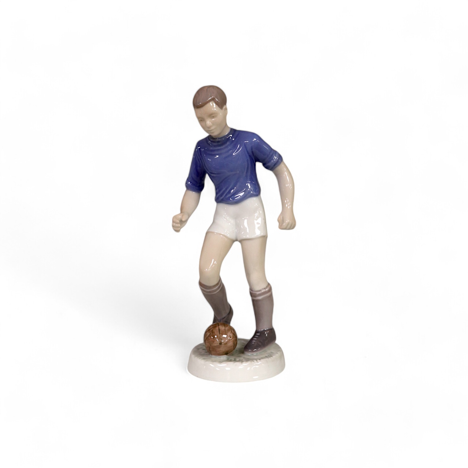 A Bing and Grondahl, Copenhagen porcelain footballer, no.2375, impressed V.T., 22cm high. Condition - good